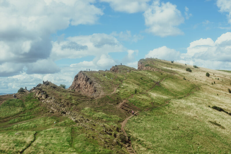 People walking the green heights of Arthur's seat