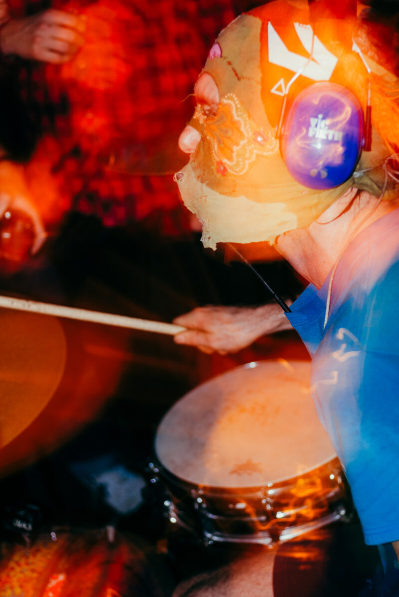 Man with mask playing drums