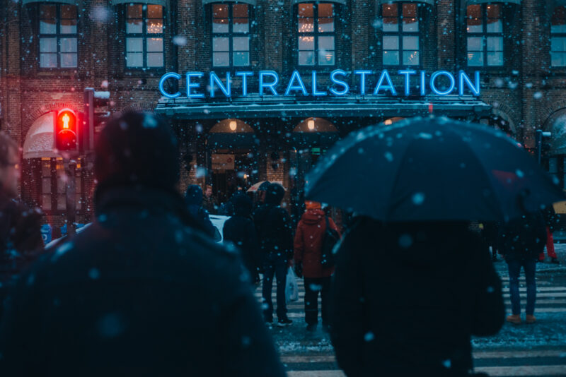 Snow falling as people are crossing the road at Gothenburg's Central Station