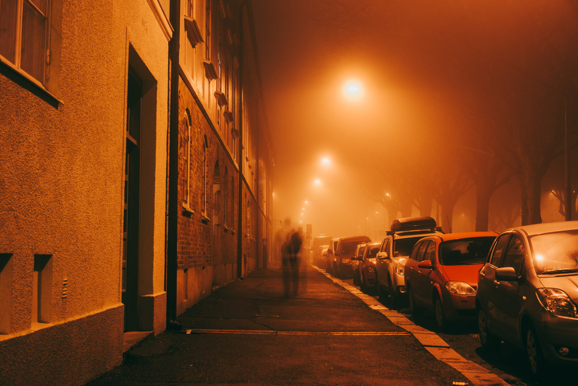 Person walking on a dark foggy street